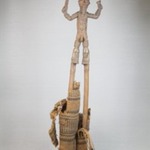 Figure of a Male Stilt Dancer Holding Knife and Horn